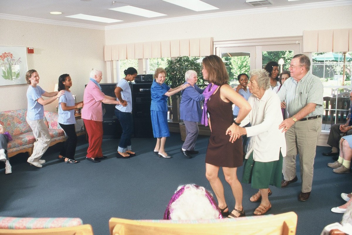 A group of people enjoying a dance session together indoors.