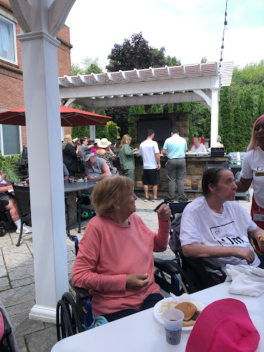 A lively outdoor gathering with people enjoying a barbecue.
