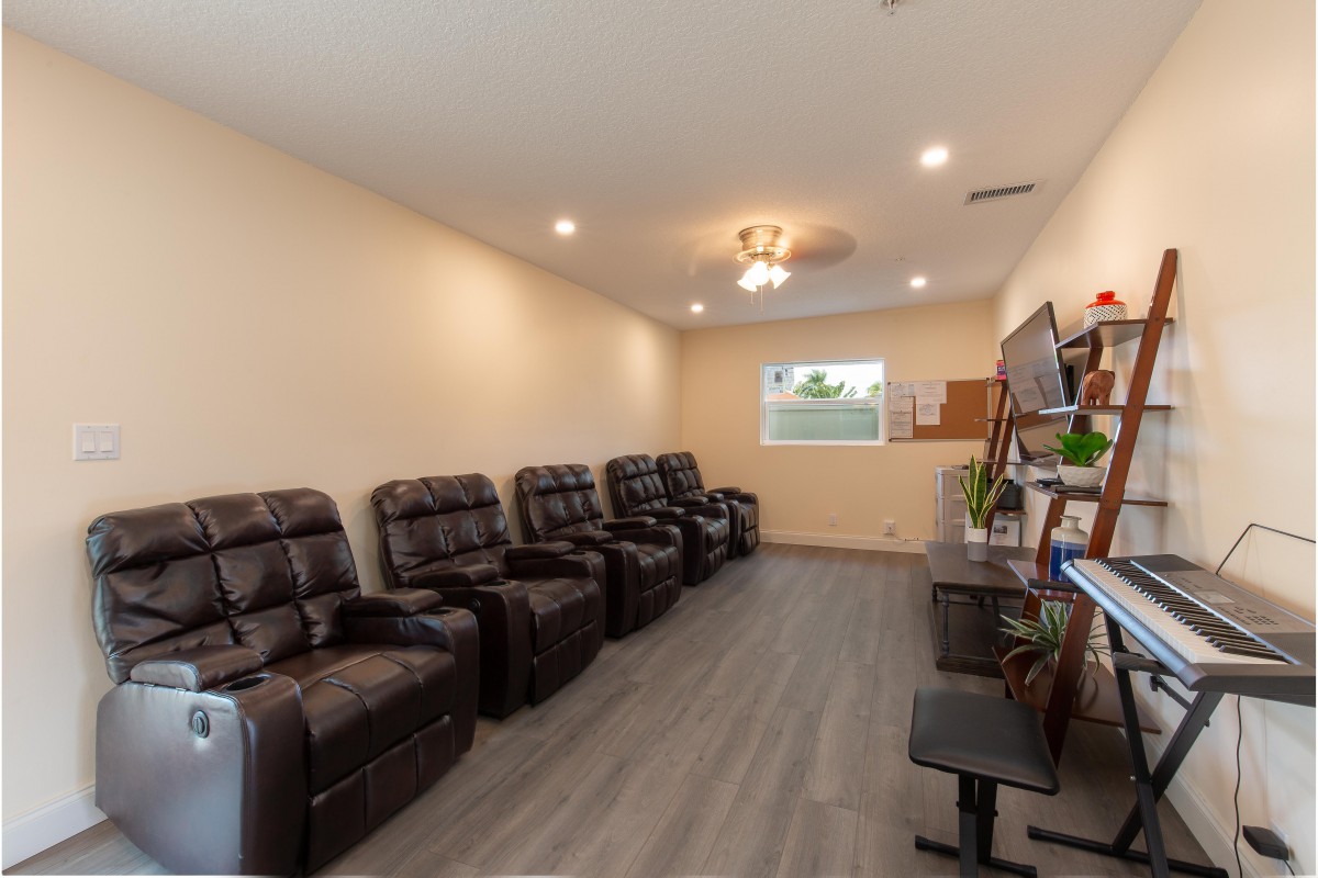 A modern waiting room with comfortable recliner chairs and elegant lighting.