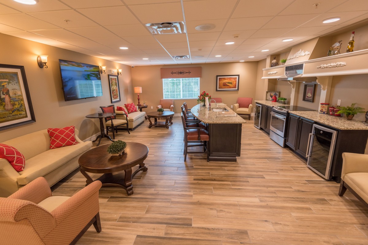 Modern open-plan living and kitchen area with hardwood floors.