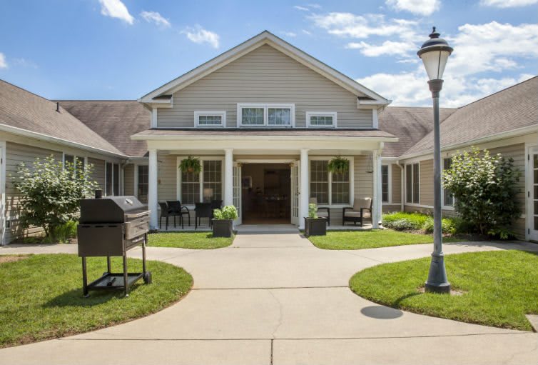 A charming residential house with a welcoming front porch and well-maintained landscaping.