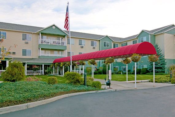 A hotel building with a red canopy entrance and an American flag.