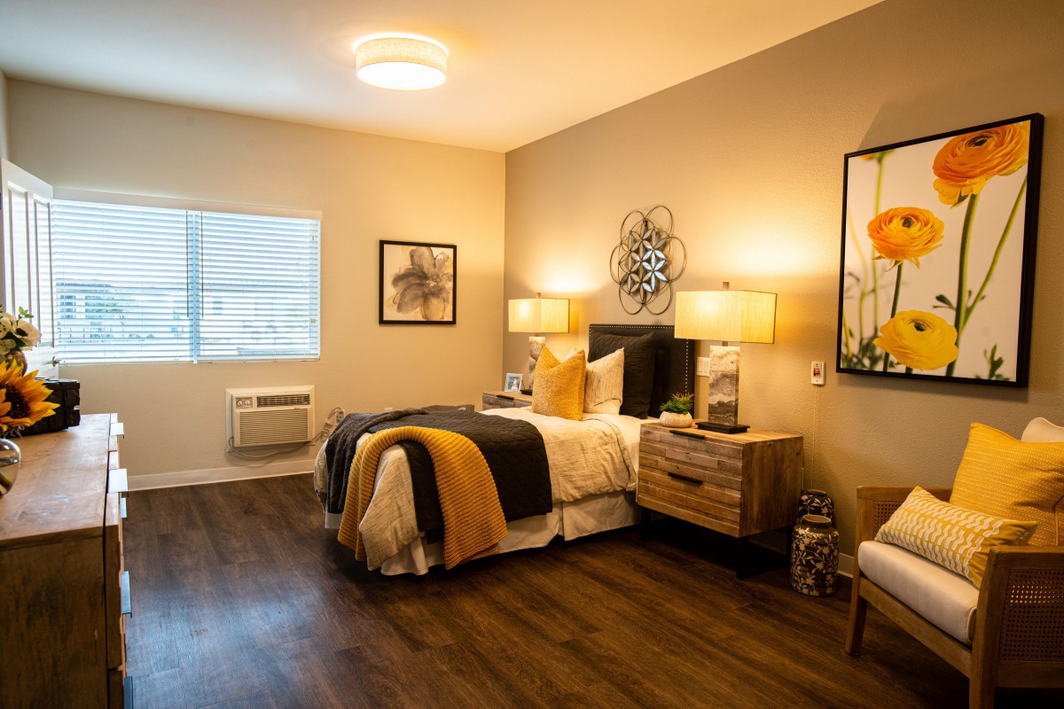 A modern and cozy bedroom interior with warm lighting and stylish decor.