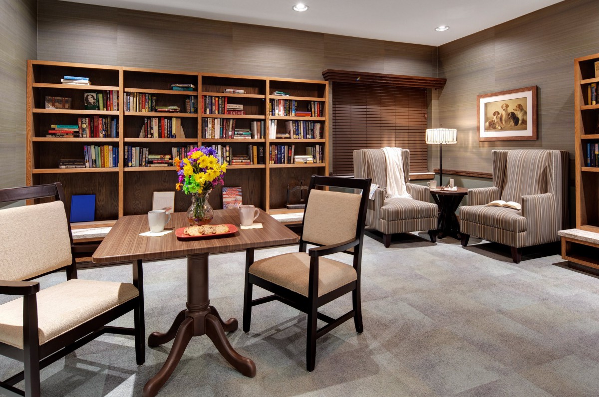 Cozy library interior with bookshelves and comfortable seating.
