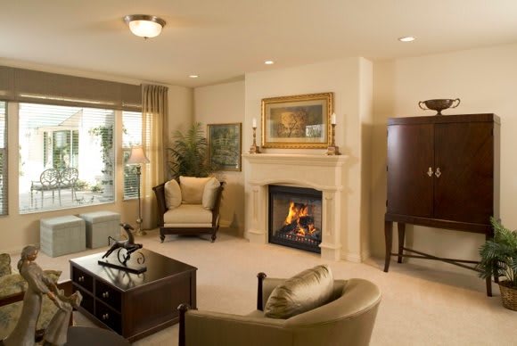 A cozy living room with a fireplace and neutral-toned decor.