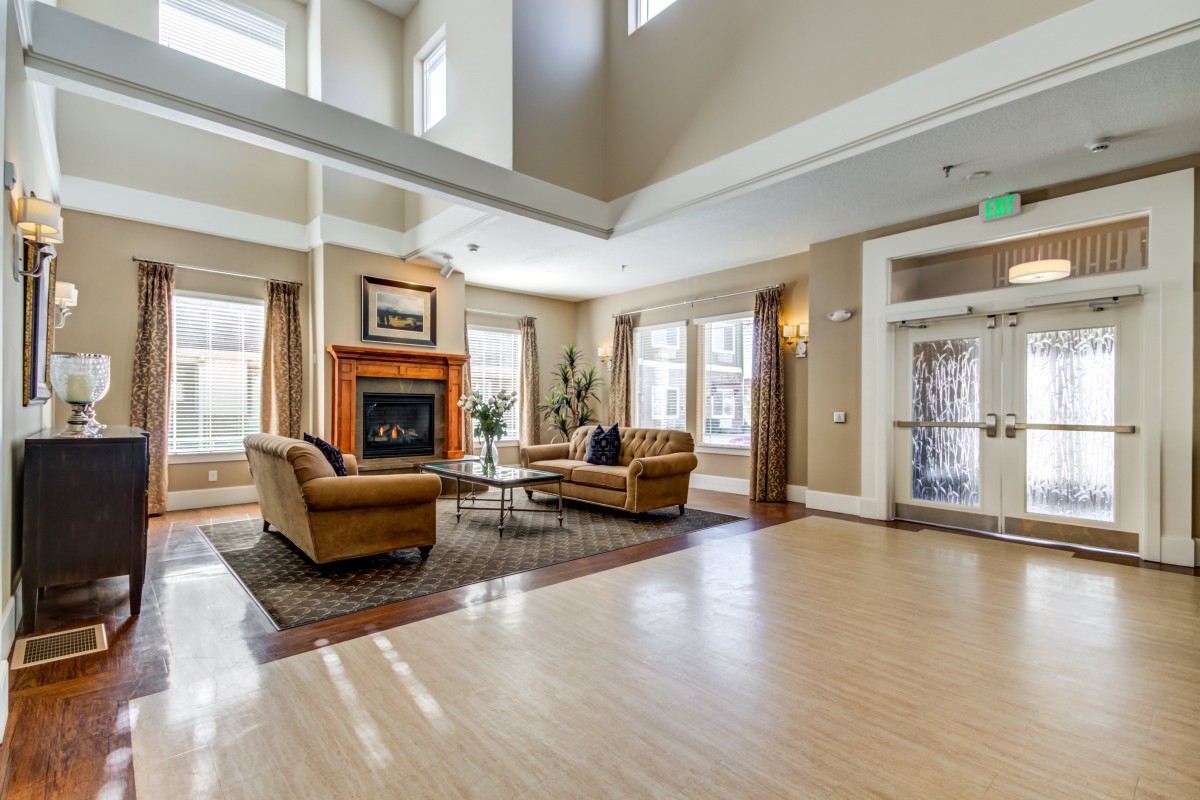 A spacious living room with a cozy fireplace and elegant furnishings.