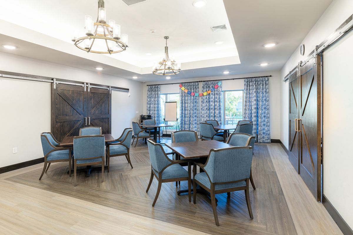 A modern dining room with elegant chandeliers and stylish furniture.