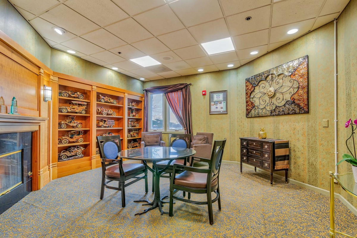 Cozy library room with bookshelves and a seating area.