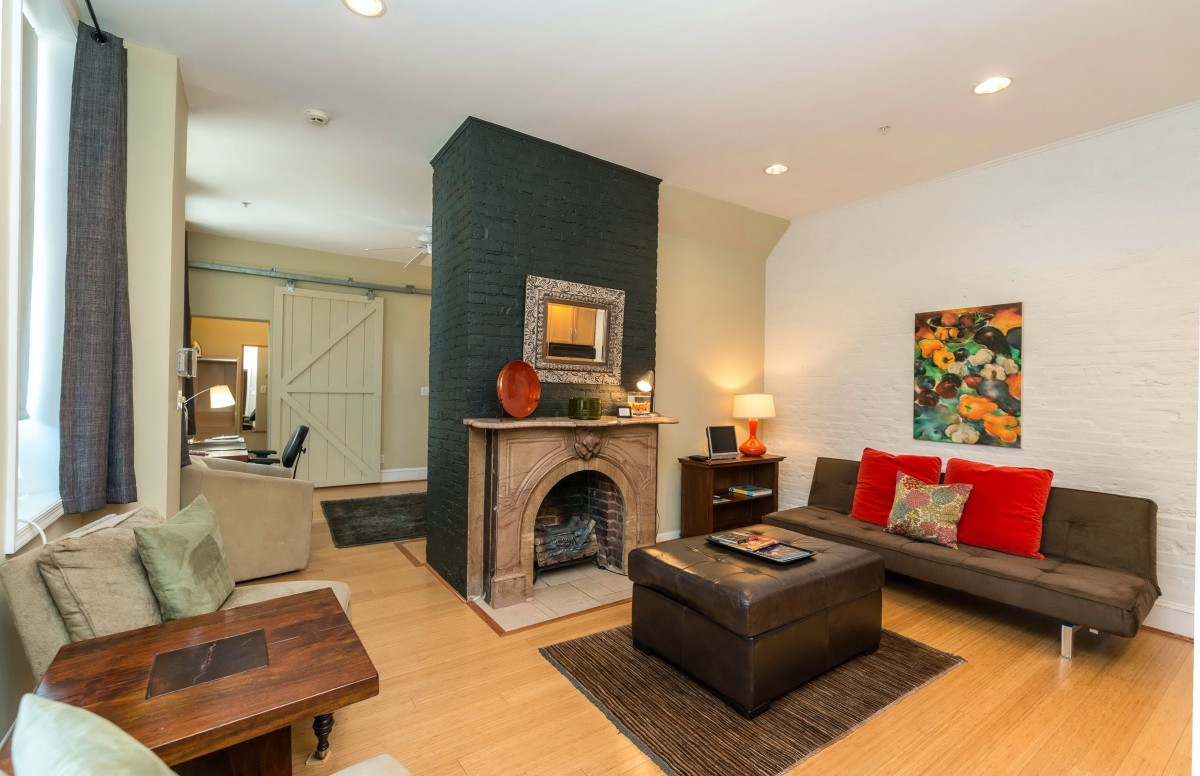 A cozy and modern living room with a central fireplace and stylish decor.