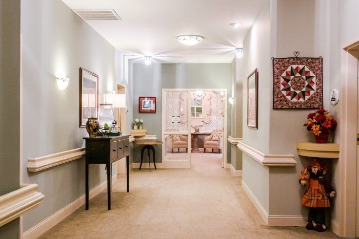 A well-decorated hallway with artwork and furnishings.