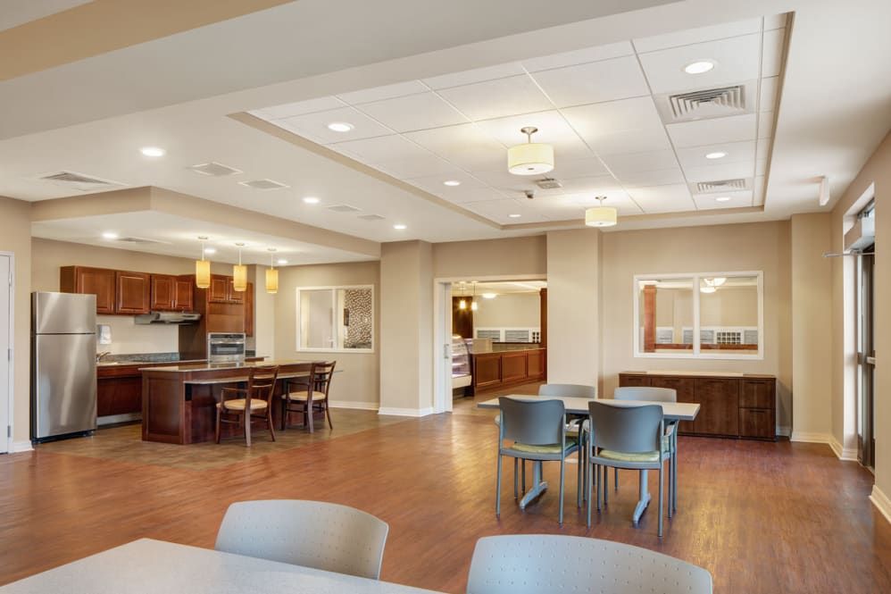 A modern dining and kitchen area with ample seating and contemporary lighting.