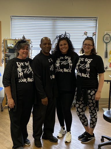 A cheerful team united in support, showcasing their spirit with matching shirts.