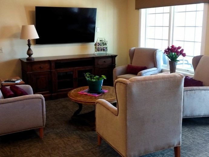 A cozy living room with comfortable seating and a large television.
