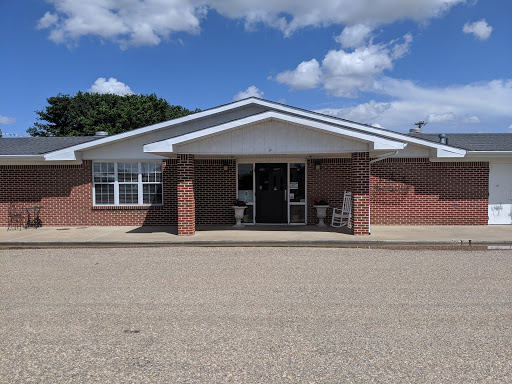A welcoming view of a brick building under a clear blue sky.