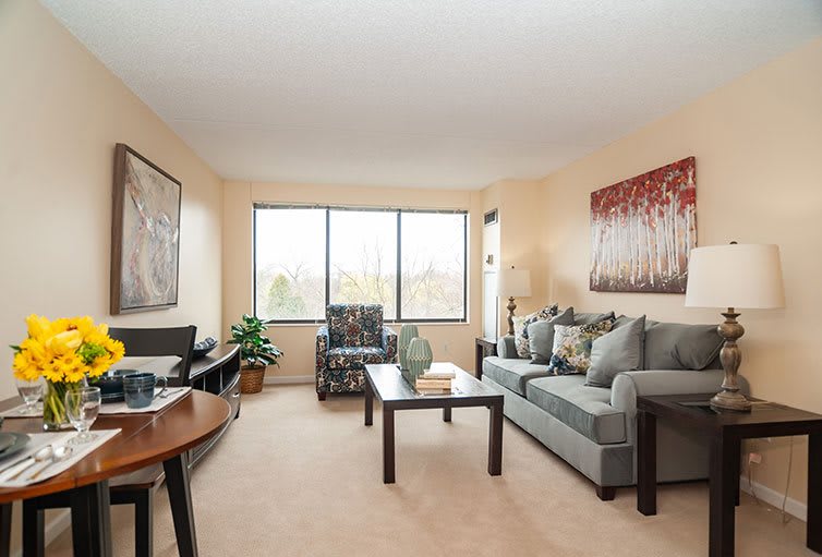 A cozy living room with modern furniture and large windows.