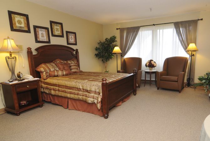 A traditional bedroom with elegant furniture and warm decor.