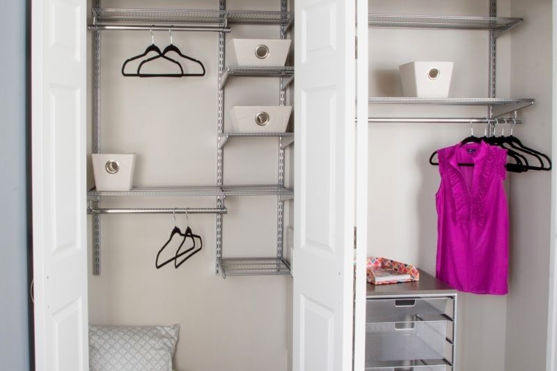 Organized closet with shelves, baskets, and hangers.