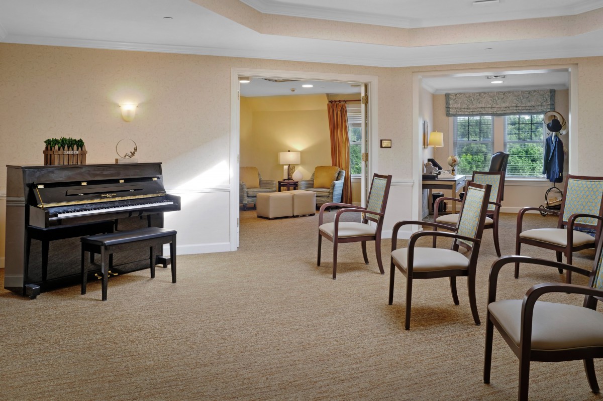 A cozy living area with a piano and chairs arranged in an inviting layout.