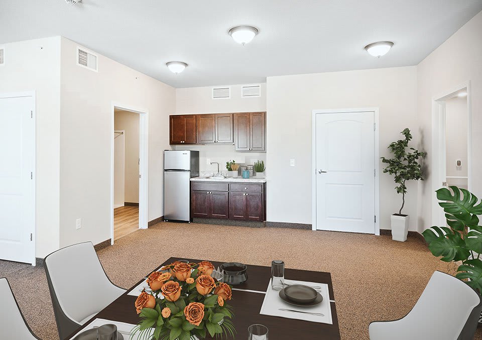 A modern apartment interior featuring a small kitchen and dining area with elegant decor.