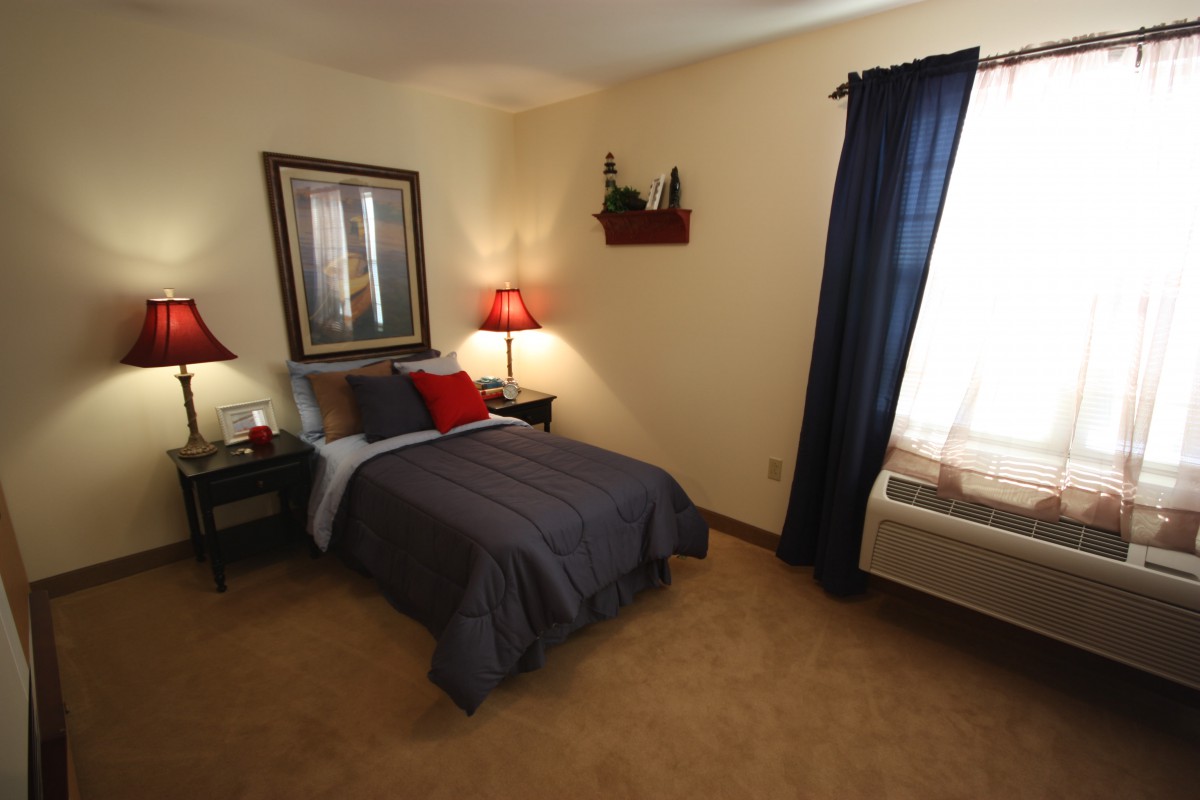 Cozy bedroom with a single bed and warm lighting.