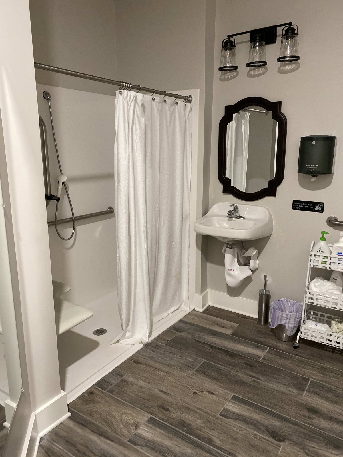 An accessible bathroom with a shower, sink, and various amenities.