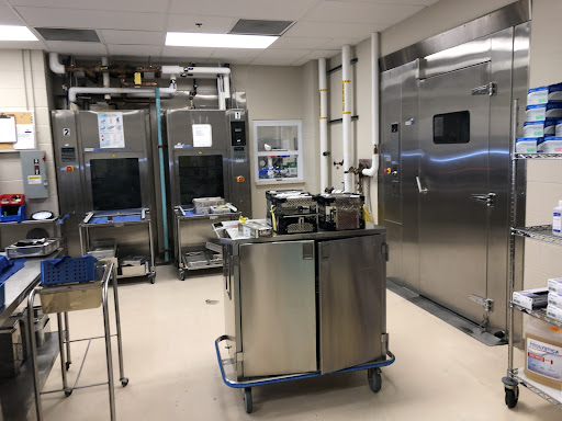 A clean and organized commercial kitchen featuring industrial-grade stainless steel appliances.