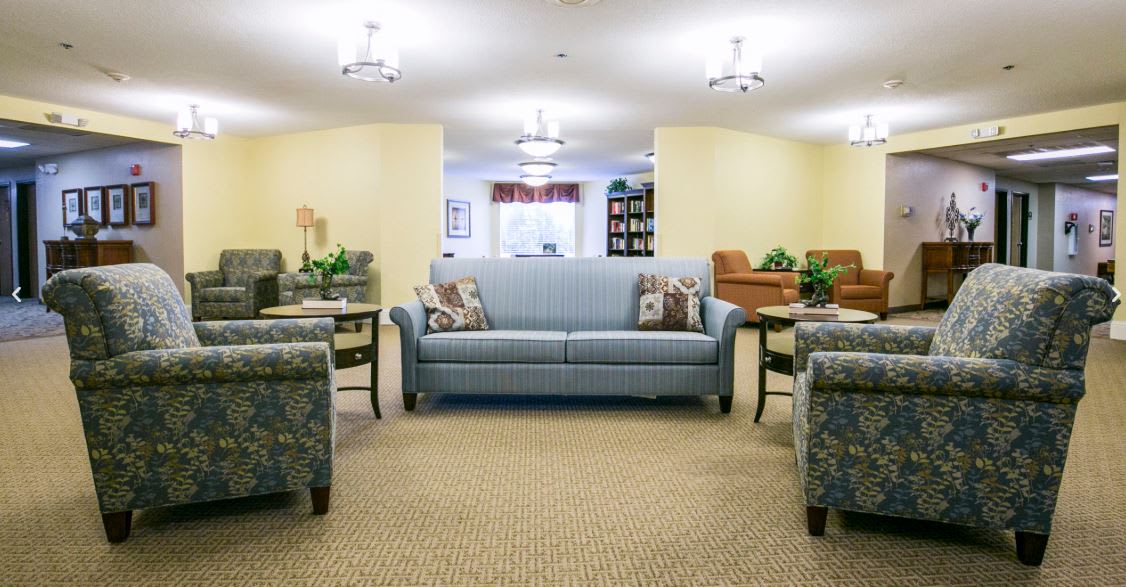 A cozy and well-furnished living room with sofas and armchairs.