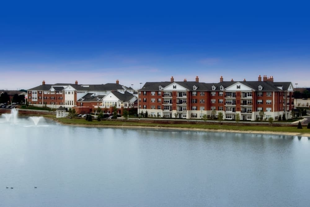 A row of waterfront apartment buildings under a clear blue sky.