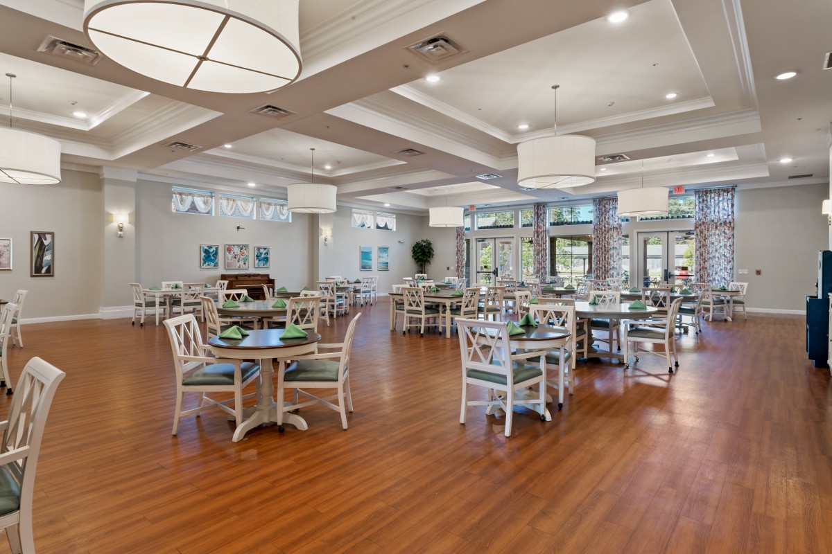 A spacious dining area with modern decor and wooden flooring.