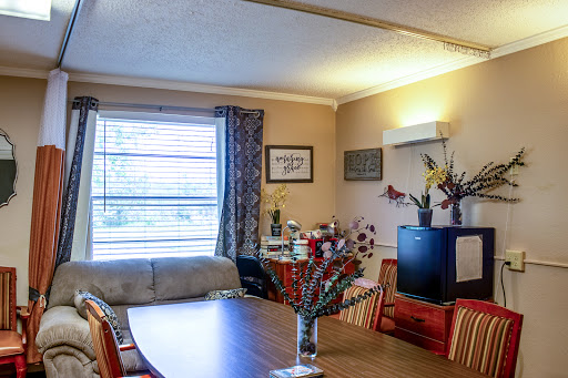 A cozy living and dining area featuring a table, sofa, and decorative elements.