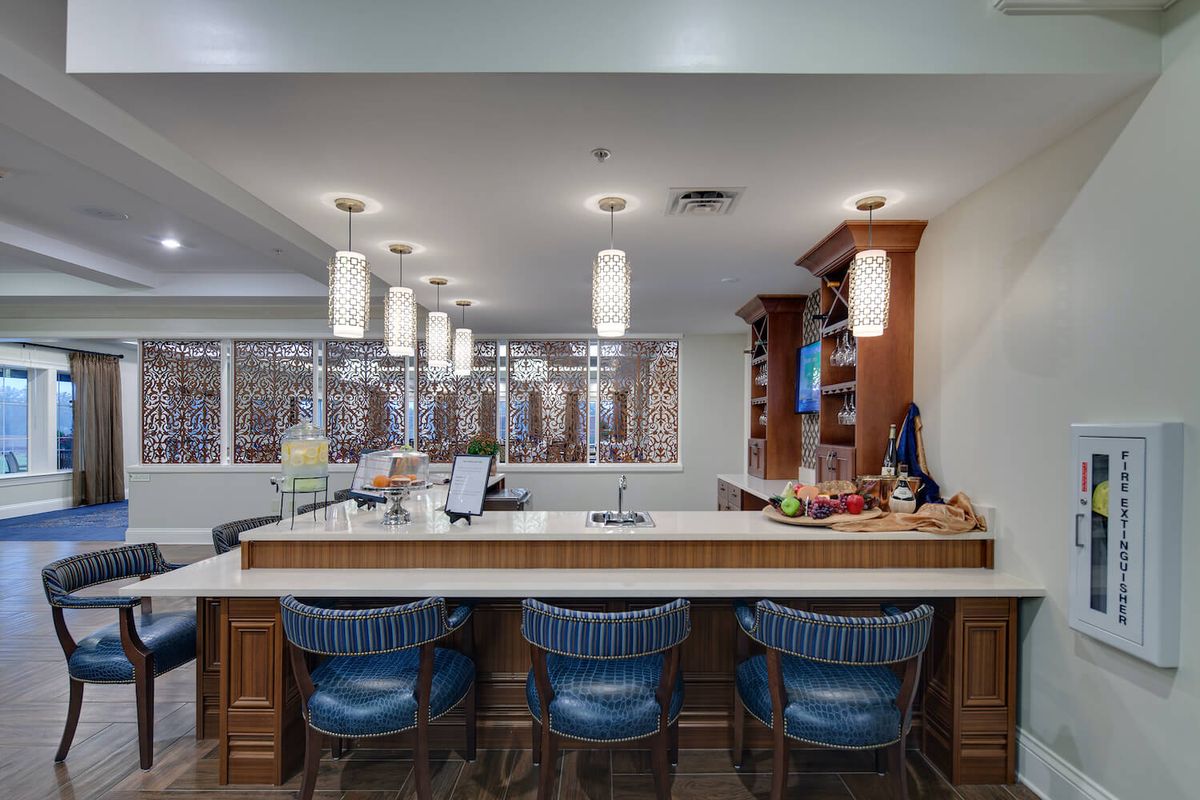 A modern bar area with stylish lighting and comfortable seating.
