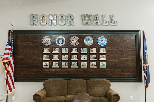 An Honor Wall displaying recognition photographs in a community space.