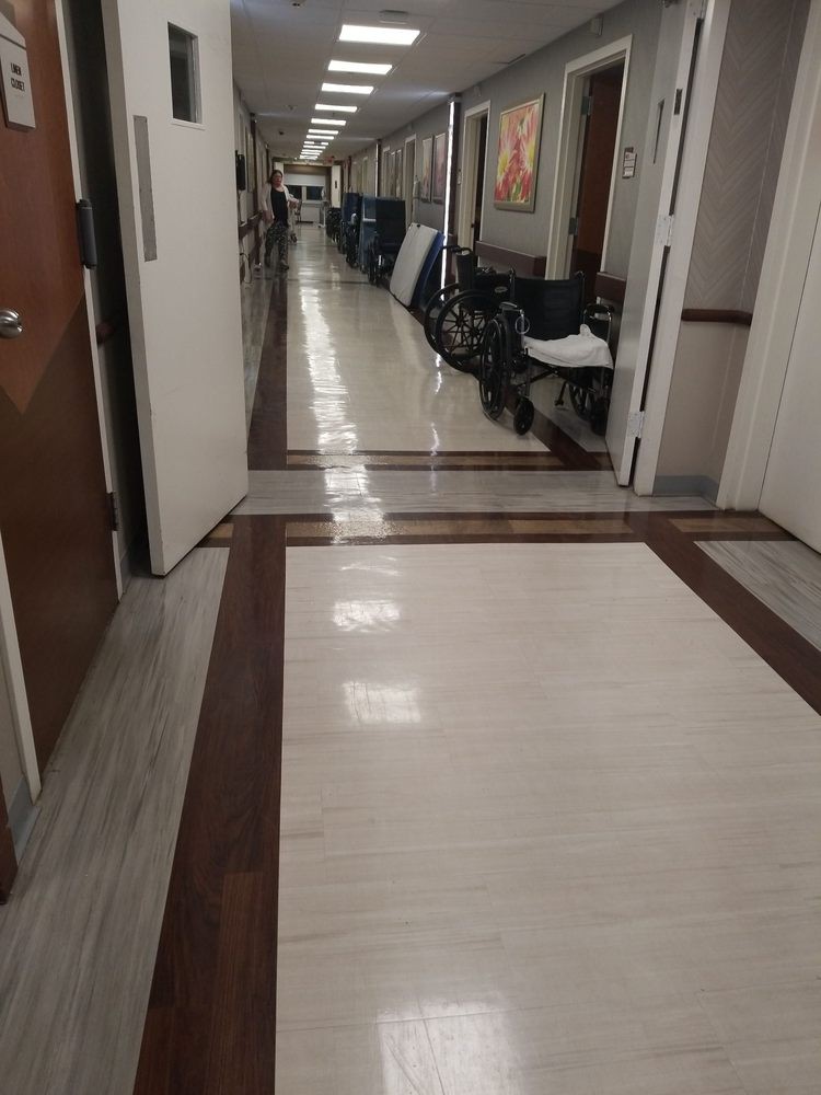 A hospital corridor with wheelchairs lining the side.