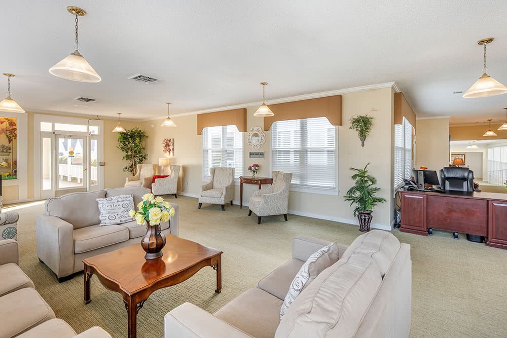 A spacious living room with comfortable seating, large windows, and elegant decor.