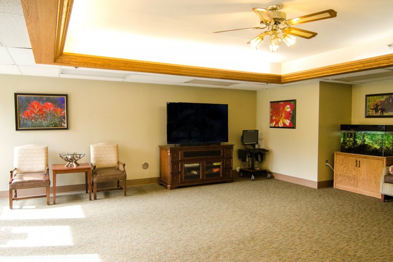 A spacious living room with a large television, comfortable seating, and tasteful decor.