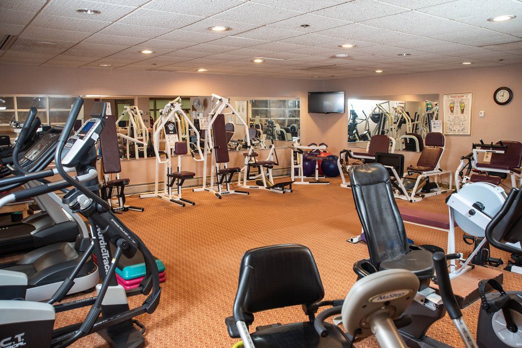 A well-equipped gym with various exercise machines and fitness equipment.