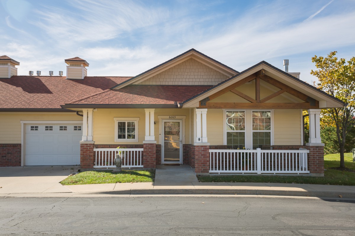 A single-story suburban house with a porch and garage.
