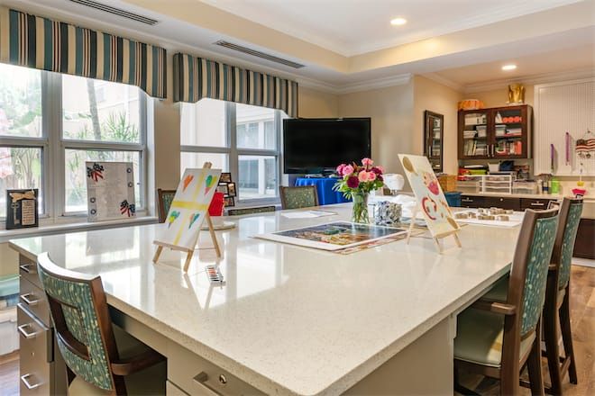 A modern kitchen interior with a large central island and bright decor.