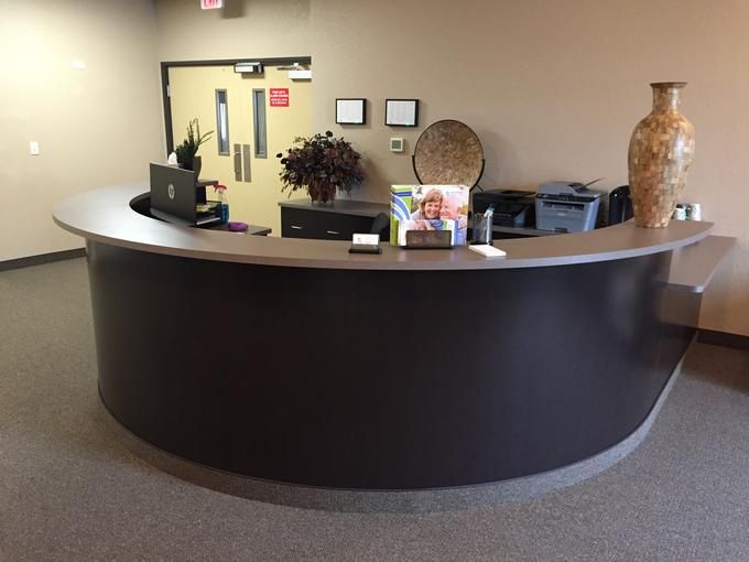 A modern reception desk in an office lobby.