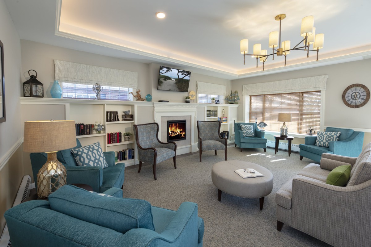 A cozy and modern living room with a fireplace and comfortable seating.