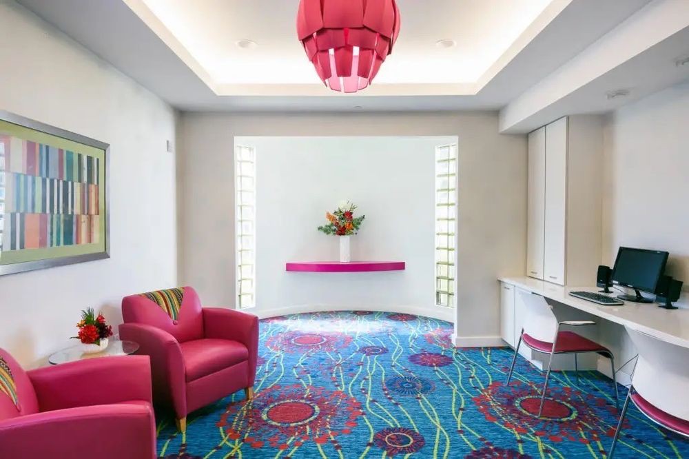A modern living room with vibrant colors and stylish furnishings.