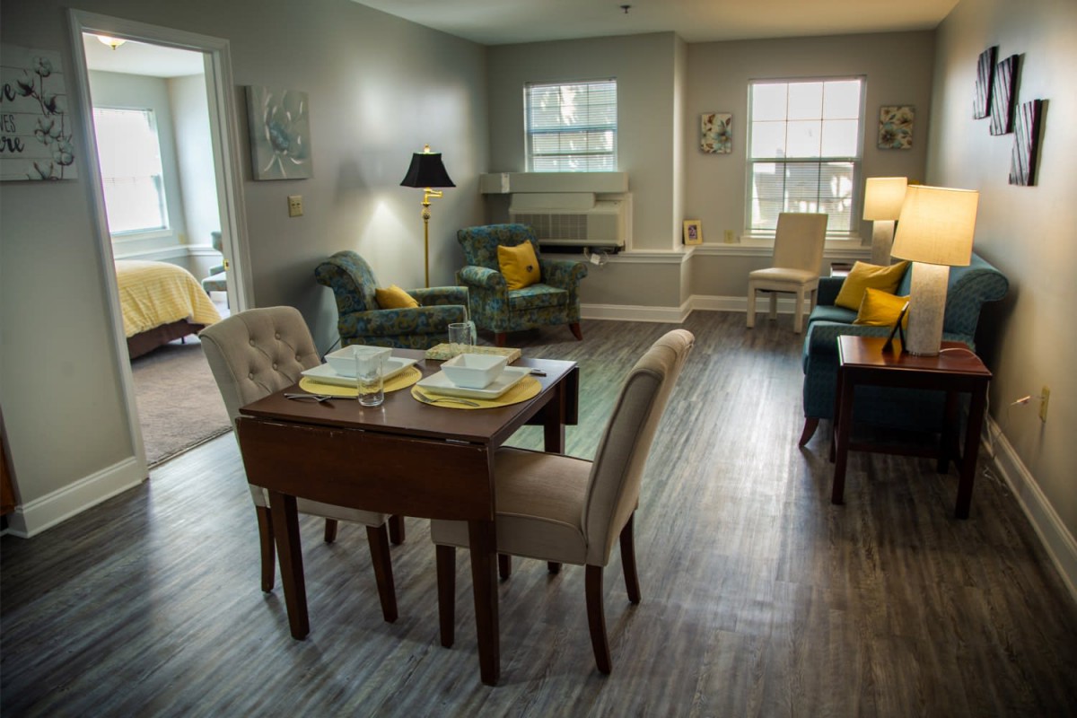 A cozy living and dining area featuring modern furniture and bright lighting.