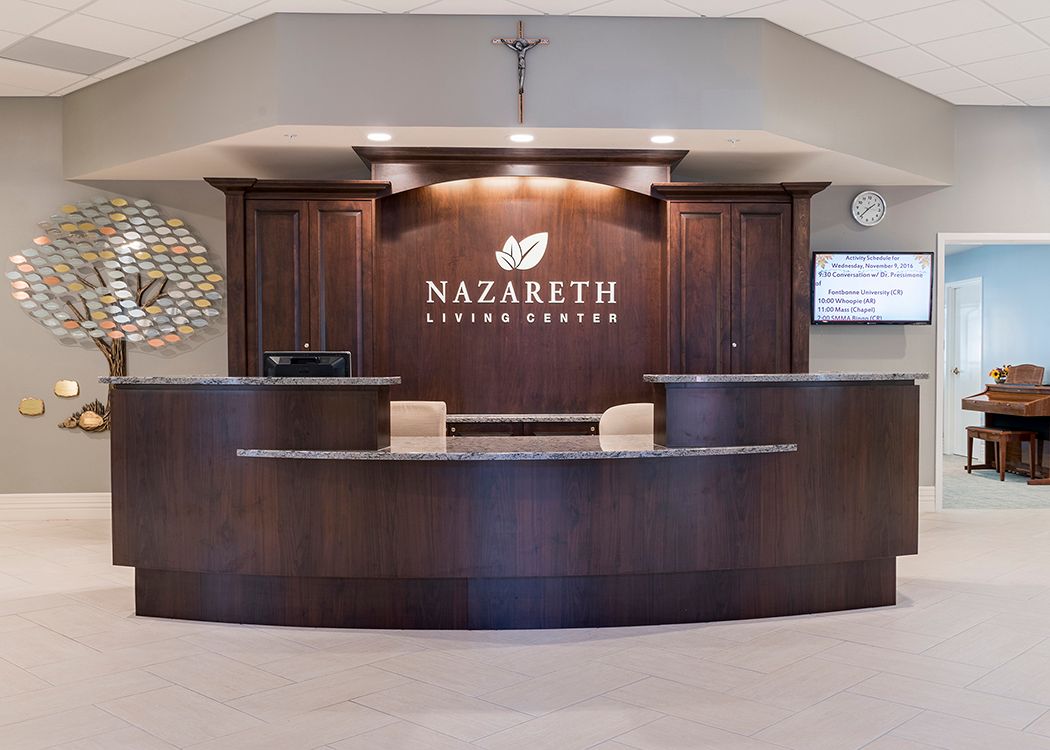 A reception desk at Nazareth Living Center with a modern, wooden design.