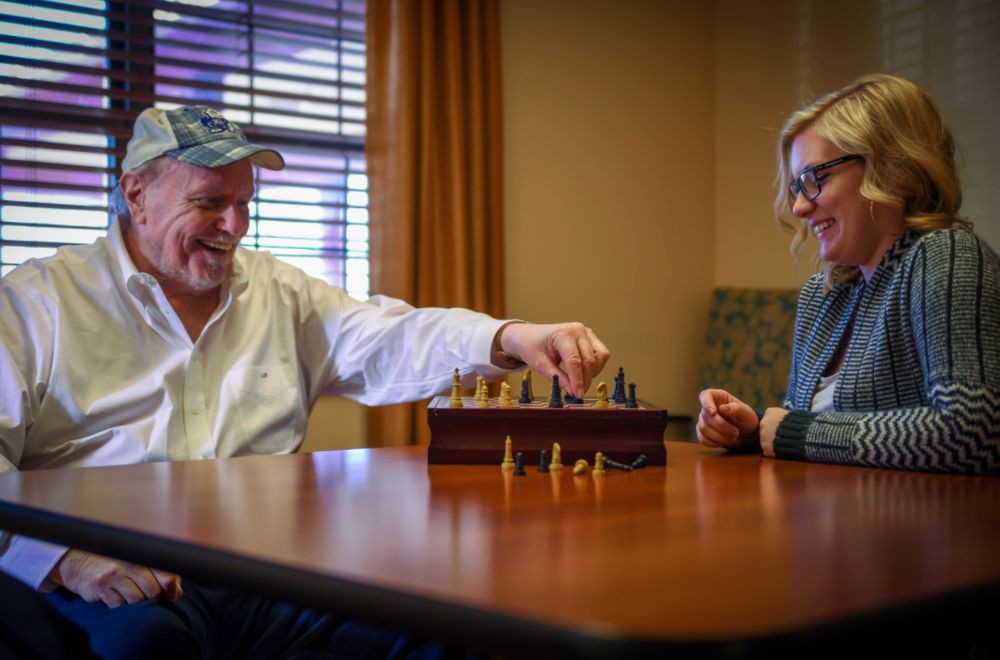 Two people enjoying a game of chess indoors.