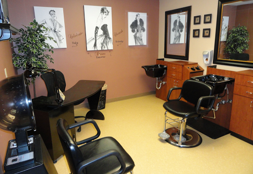 A stylish and welcoming hair salon featuring barber chairs and artistic wall decor.