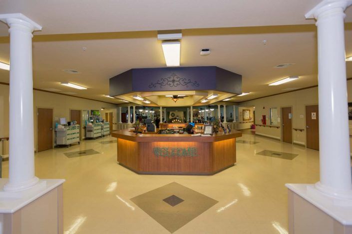 A hospital reception area with a central desk.