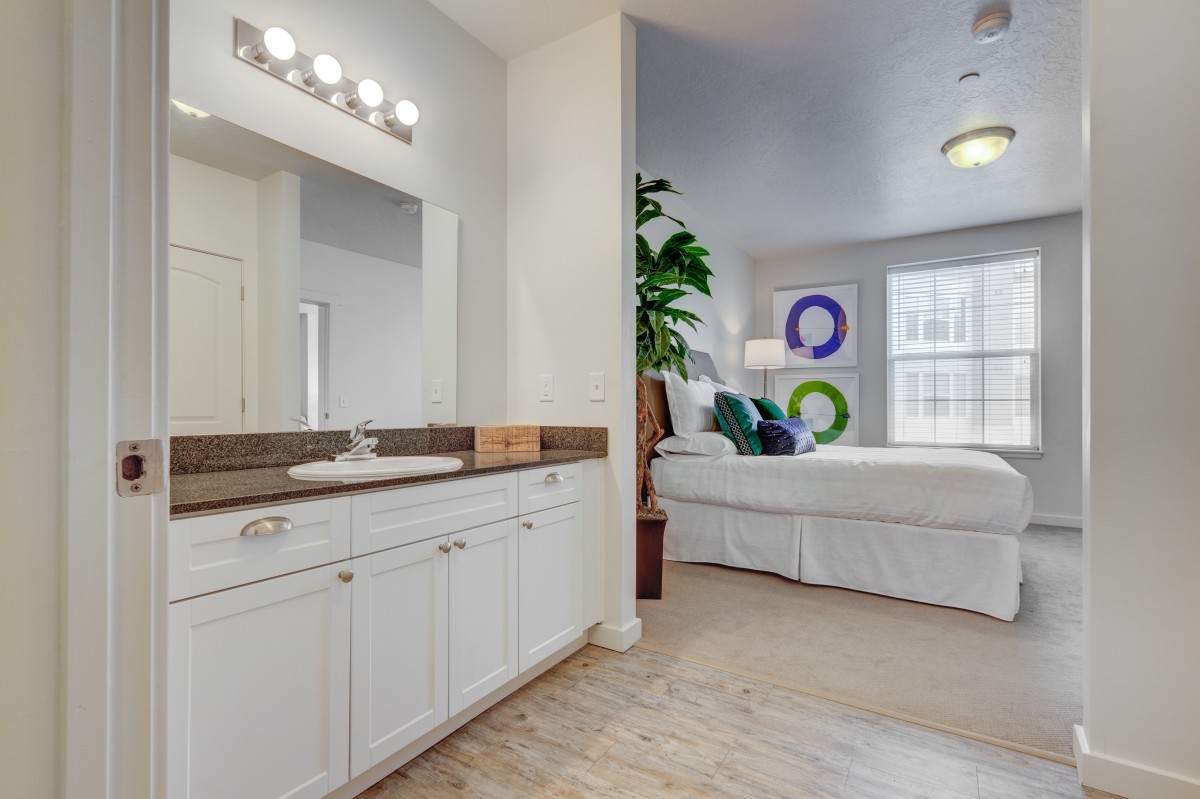 A modern open-concept bedroom and bathroom space featuring stylish decor and furnishings.