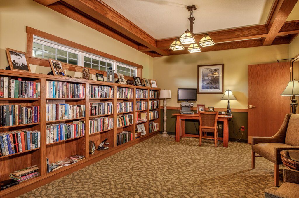 A cozy study room with bookshelves and a wooden desk.