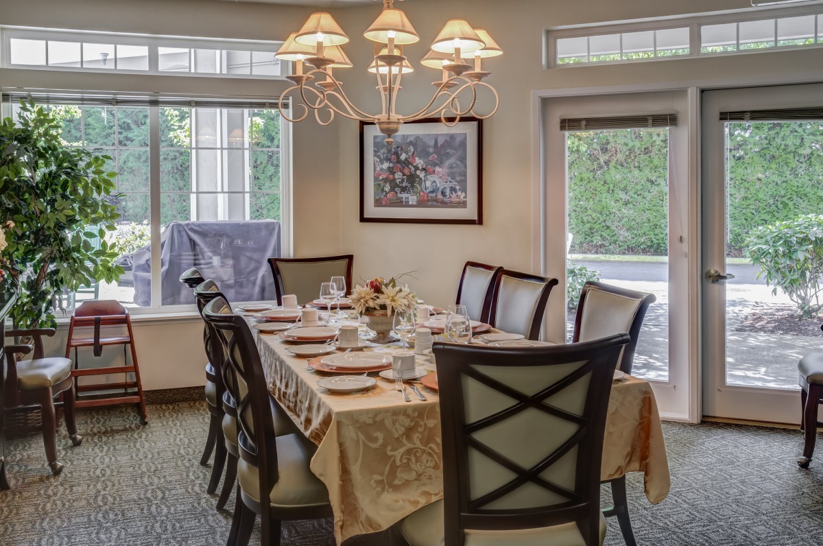 A well-set dining room table with elegant decor and ample natural light.