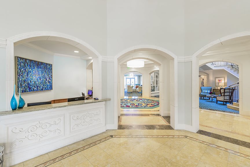 A modern lobby area featuring a reception desk and elegant arches.